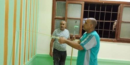 مدير مدرسة بقنا يشارك معلميه في دهان الفصول استعدادًا للعام الدراسي الجديد - مصدرنا الإخبارى
